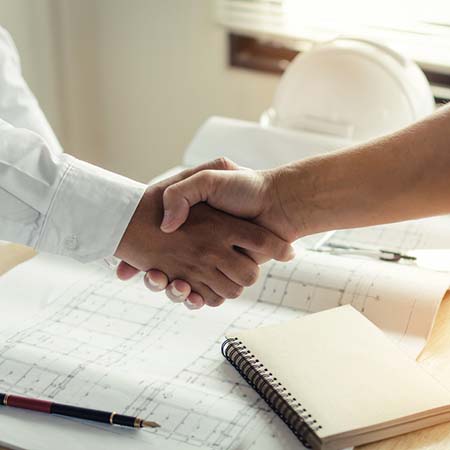 Construction Worker Shaking Hands With Customer After Finishing